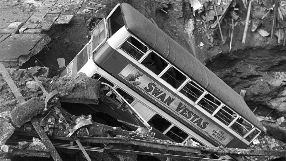 Bus in bomb crater