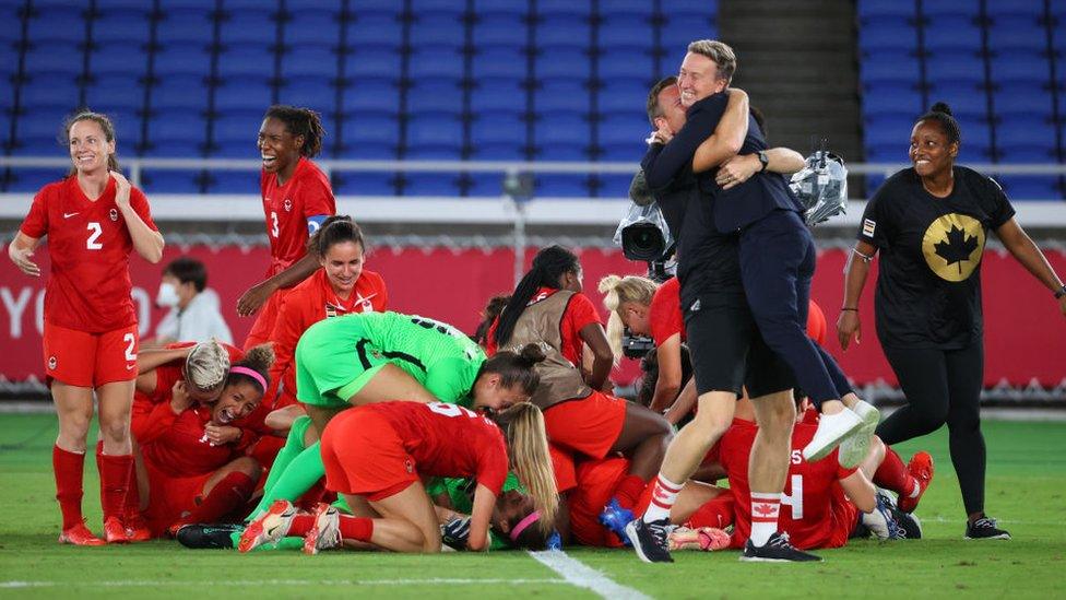 Team Canada Head Coach Beverly Priestman celebrates after defeating Team Sweden in a penalty kick shoot-out to win the women's football gold medal match between Canada and Sweden