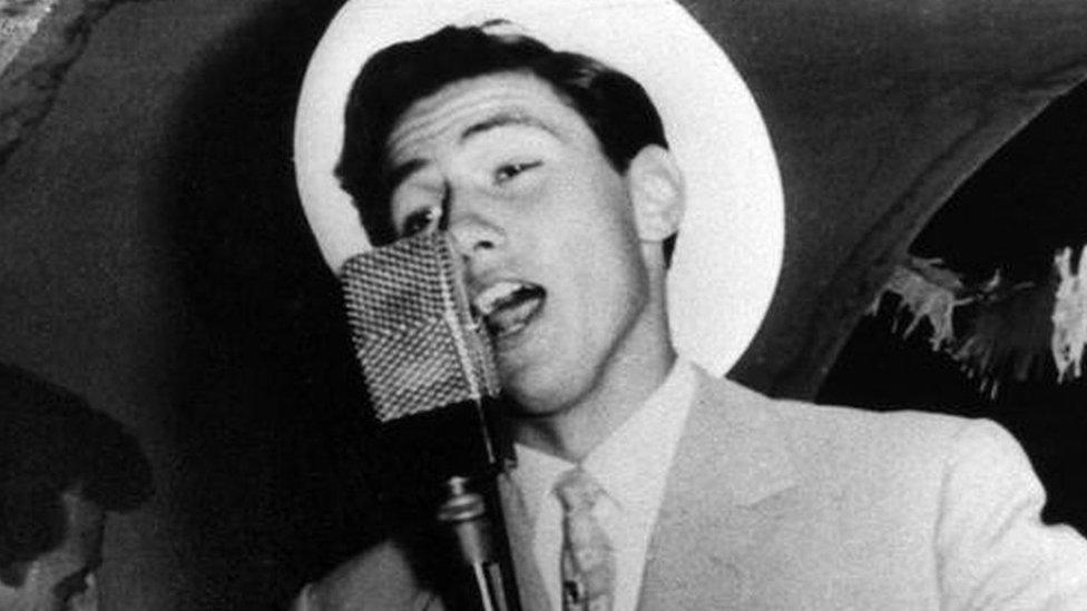 Silvio Berlusconi singing on board a cruise ship