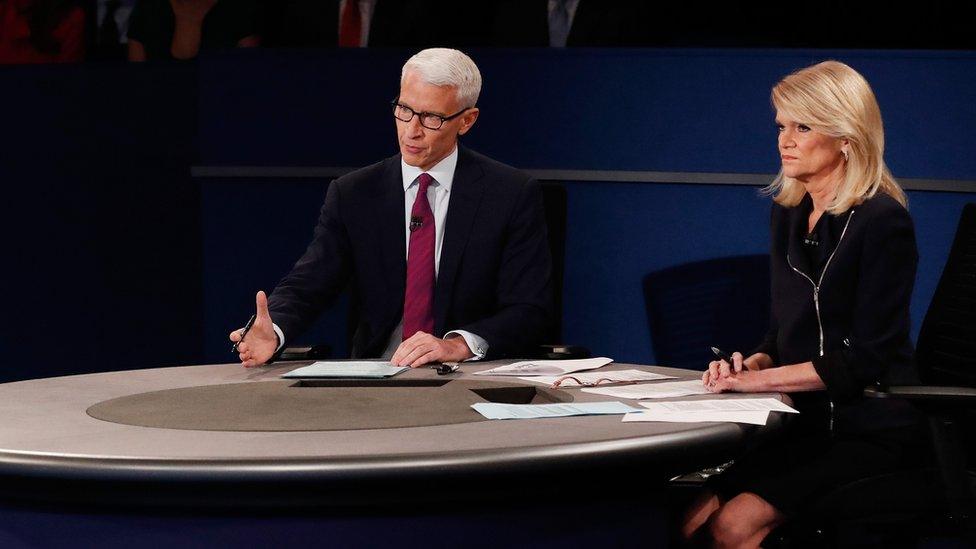 Moderator Anderson Cooper of CNN (L) speaks as moderator Martha Raddatz of ABC looks on