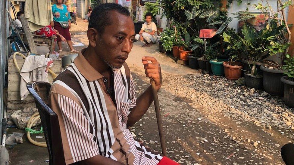 Kardi sitting in the street near his home