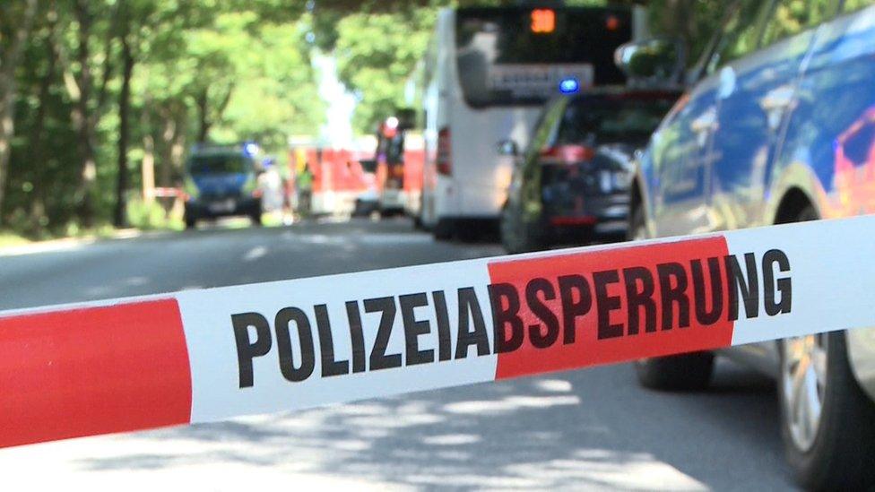 A police ribbon cordons off a street where a public service bus stands in Kücknitz near Lübeck northern Germany, after several people were injured in the bus in an assault by a man wielding a knife on July 20, 2018.