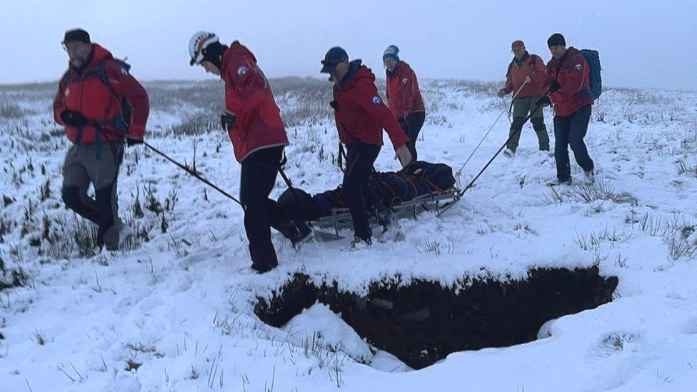 A casualty is transported to an ambulance