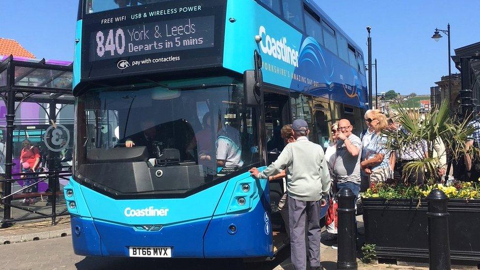 Passengers getting on bus