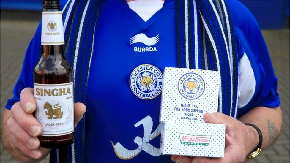 Leicester City fan holds his free beer and doughnut before the Premier League match against Southampton at the King Power Stadium