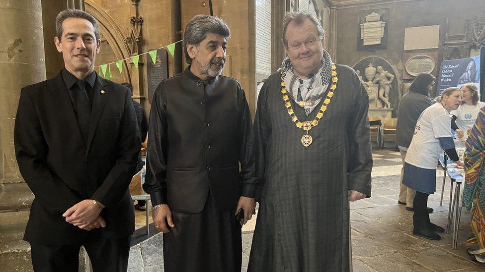 Three men standing in the cathedral