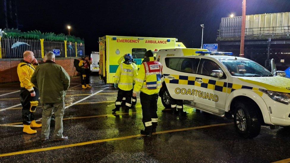 Emergency workers await the arrival of a rower lost at sea