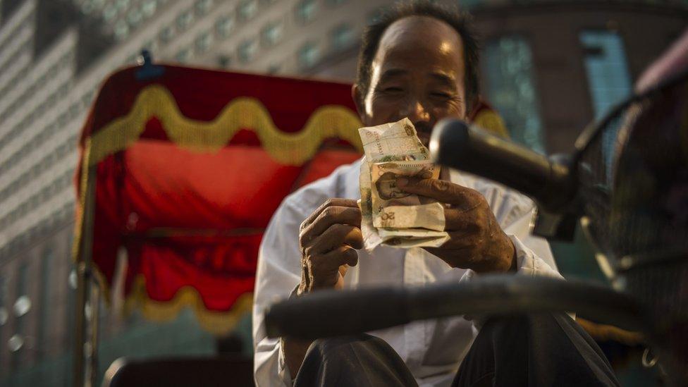 Man on bike counting money