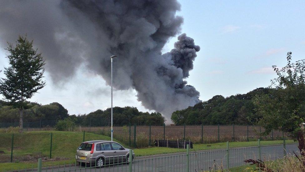 Smoke rising from the industrial estate