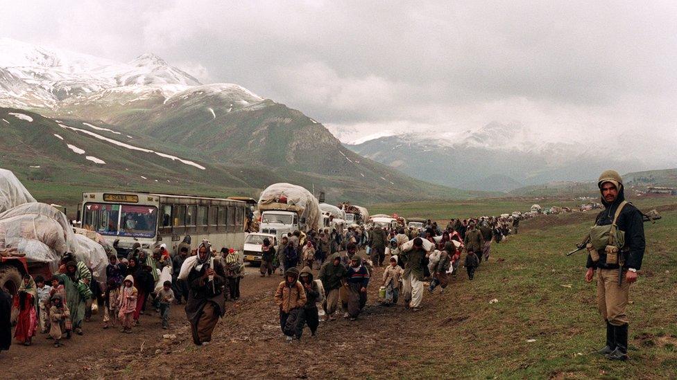 Thousands of Iraqi Kurdish refugees cross the Iraq-Iran border at Hadji Omran point near Piranshar 12 April 1991