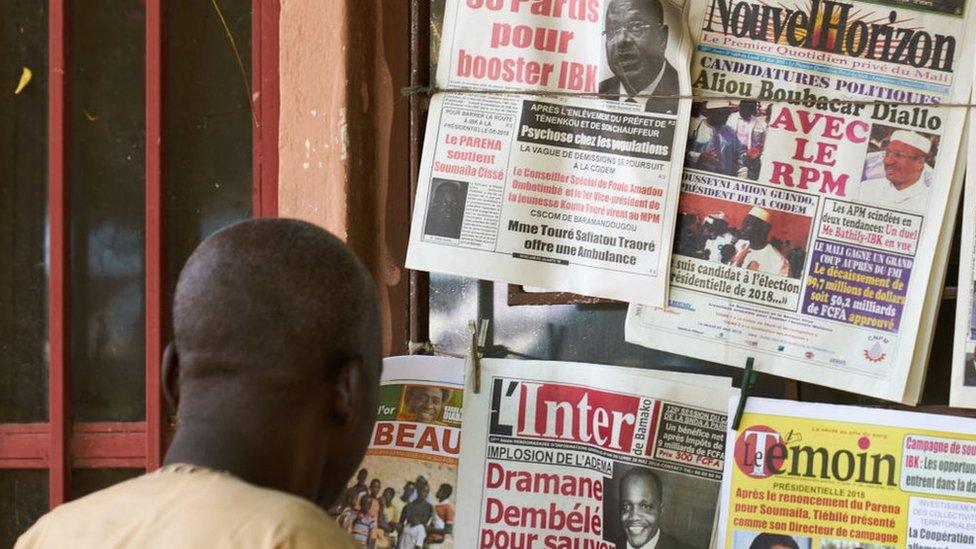 A man reads newspaper in Bamako on 28 May 2018 as Malia's president declared his candidacy for the next presidential elections