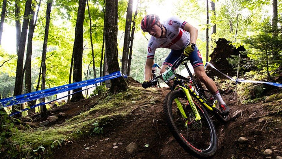 Charlie riding bike through forest