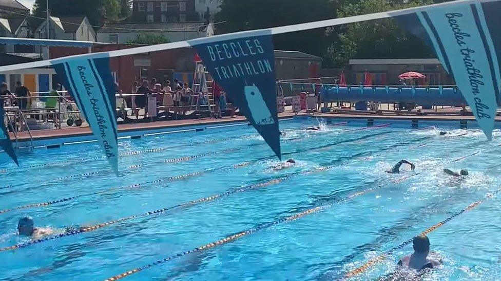 Triathlon under way at Beccles Lido, with swimmers in the pool