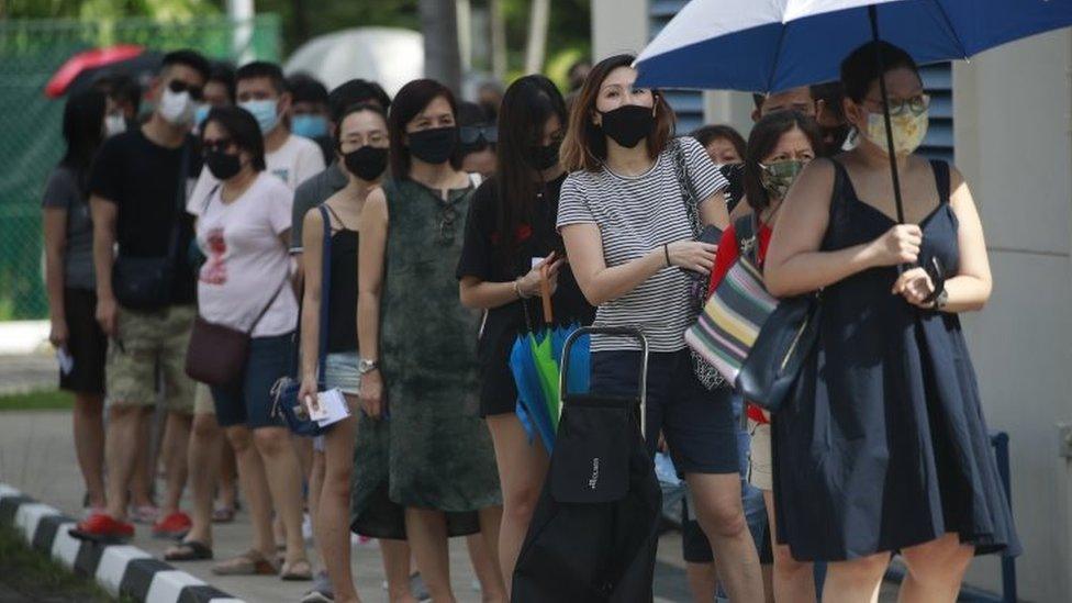 People queue to vote in Singapore (10 July)