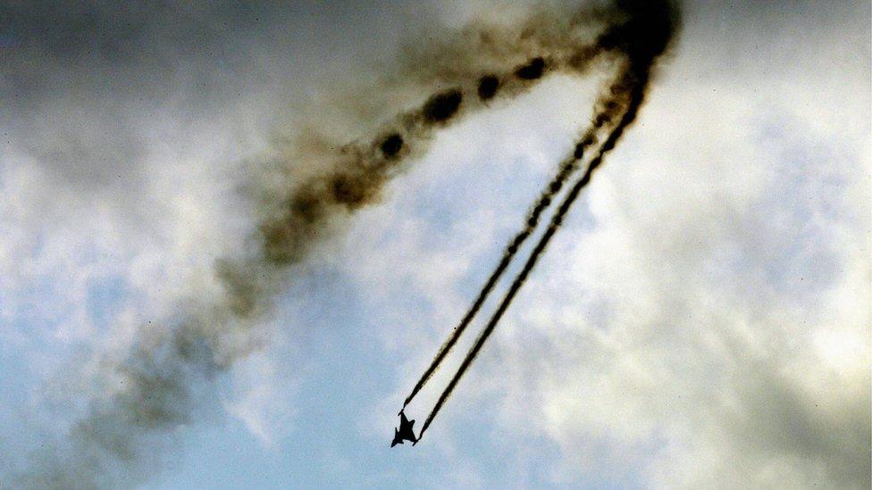 A Swedish Gripen fighter puts on an aerial display at the Farnborough air show, July 2004