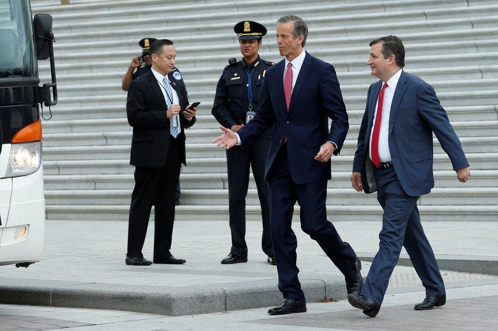 US Senators John Thune (R-SD) and Ted Cruz (R-TX), (R), walk to a Senate caravan bus from Capitol Hill to attend a North Korea briefing at the White House, in Washington, 26 April