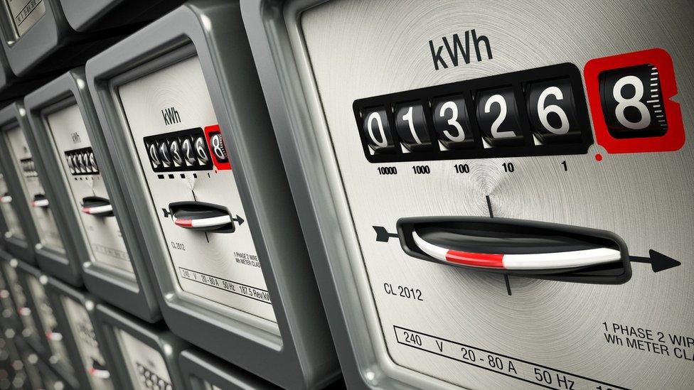 Electric meters in a row on a wall