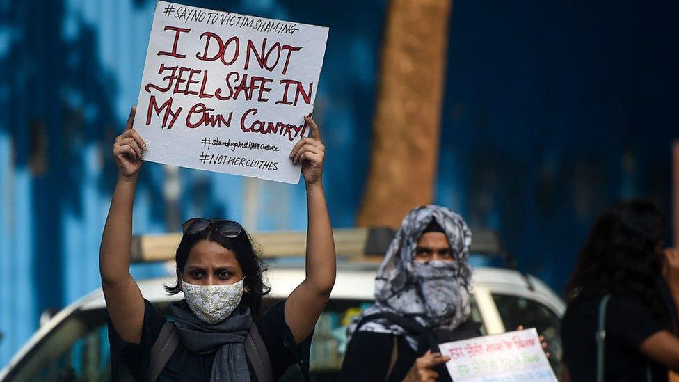 Activists hold placards during a protest to condemn the alleged gang-rape and murder of a 19-year-old woman in Bool Garhi village of Uttar Pradesh state, in Mumbai on October 6, 2020.