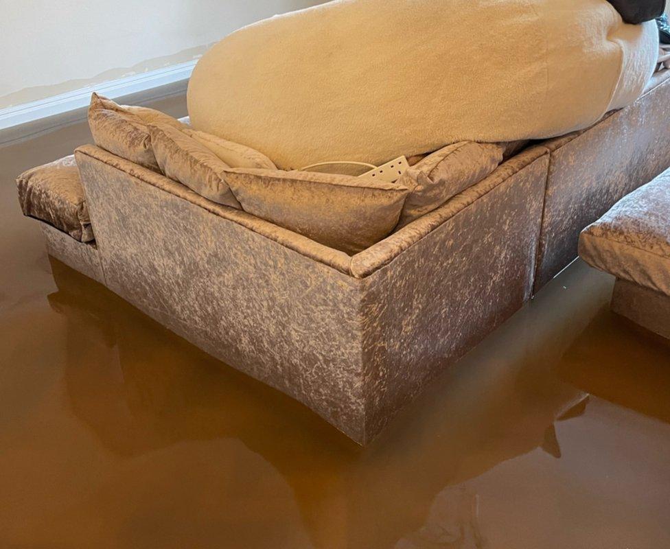 Sofa surrounded by flood water