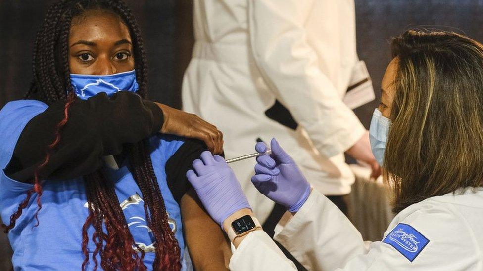 A young woman is vaccinated