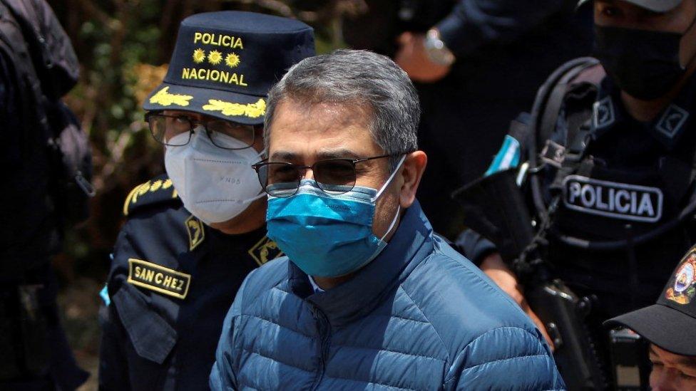 Honduras former President Juan Orlando Hernandez is escorted by members of the National Police