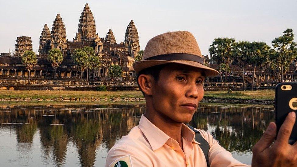 Angkor guide taking a selfie outside Angkor Wat.