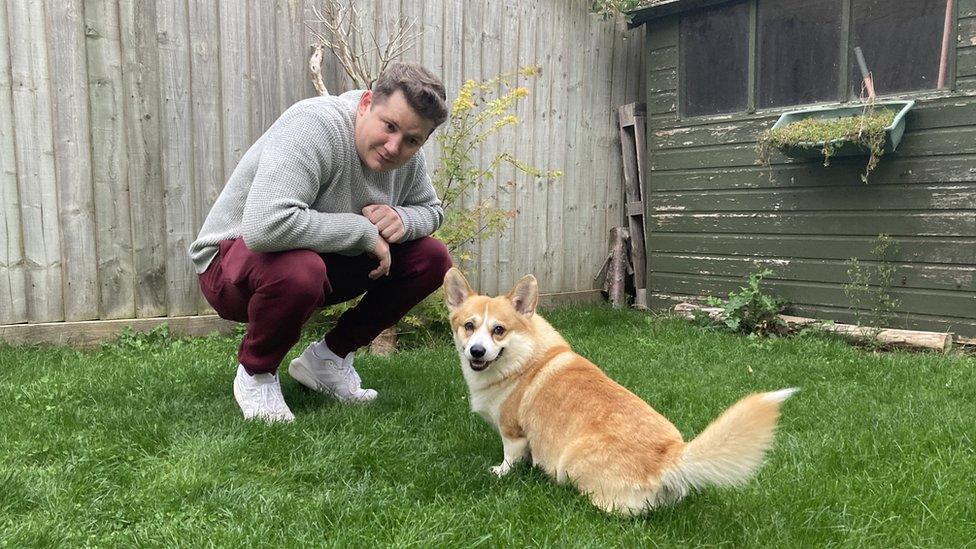 Dan Callaghan squatting next to his dog Rupert