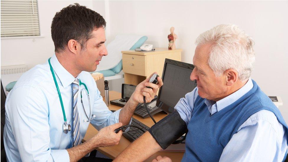 A doctor and patient at a GP surgery