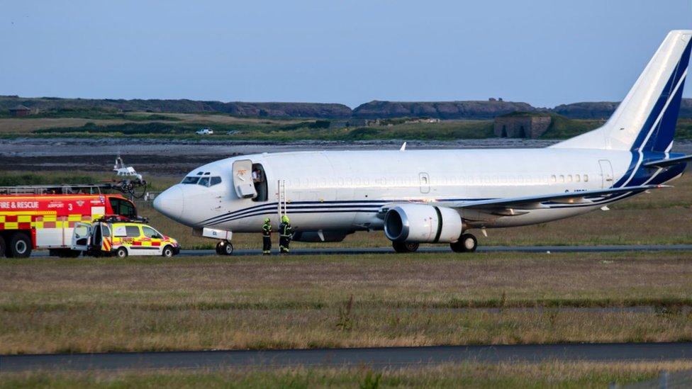 Emergency vehicles next to aircraft