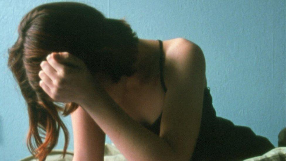 Teenage girl covering her face, file pic