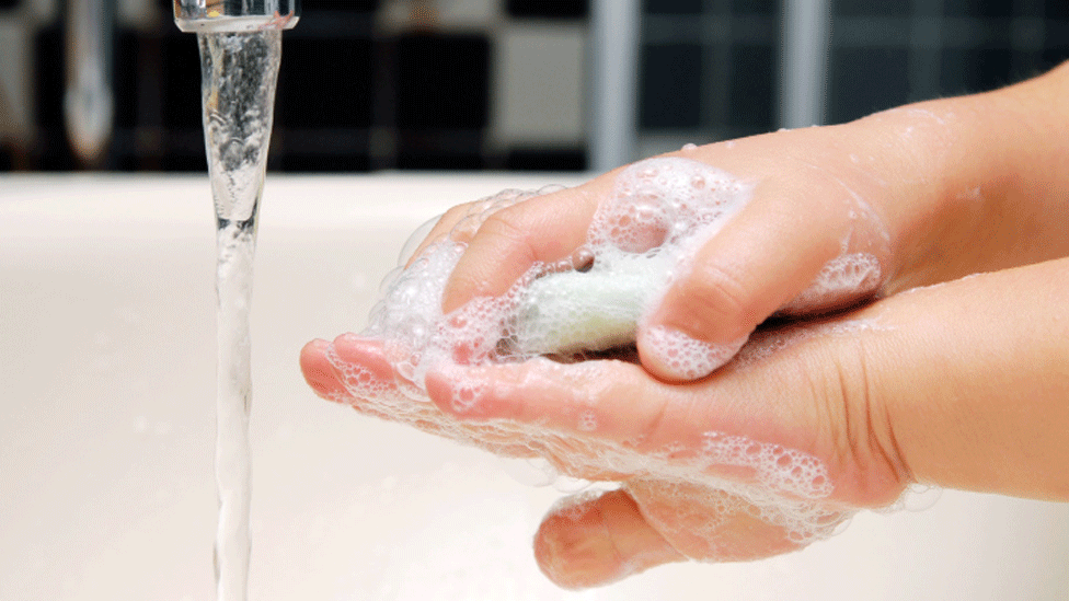 Child washing their hands