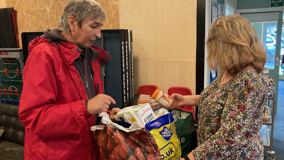 man and woman in foodbank