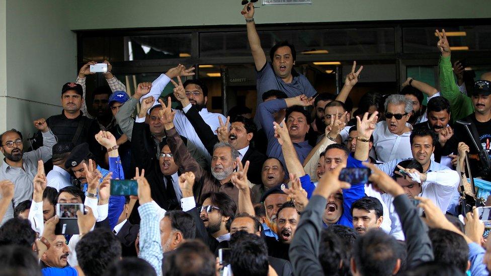 Opponents of Pakistan's Nawaz Sharif shout slogans as they exit the Supreme Court in Islamabad