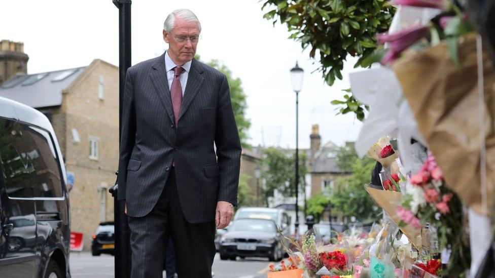 Sir Martin Moore-Bick looking at tributes left near Grenfell Tower