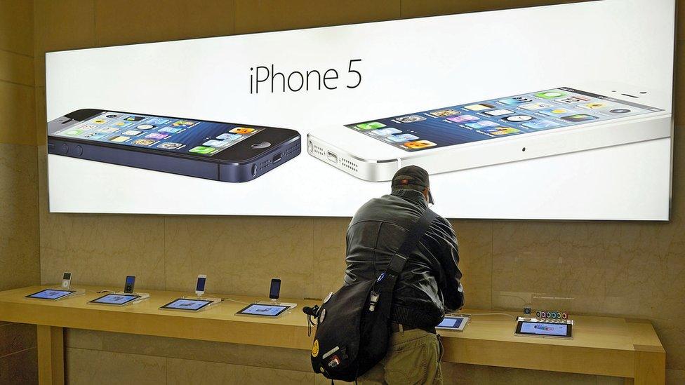 Man pictured in an Apple store using the iPhone 5, New York City, 2013