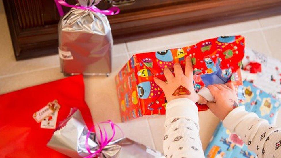 Gift wrapped presents being opened