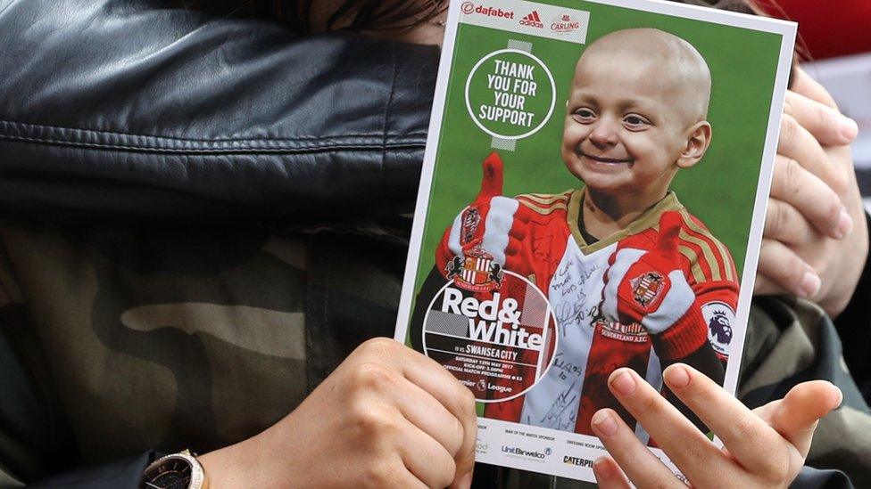 Fans hold a match day programme featuring Bradley Lowery