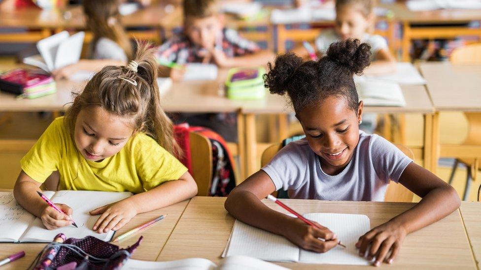 Two children sit a test