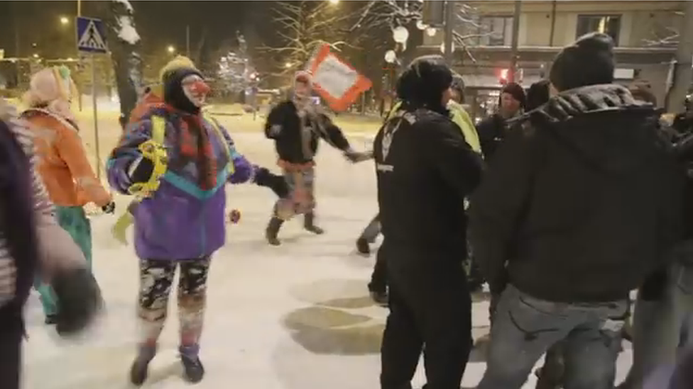 The clowns skip around the Soldiers of Odin street patrol