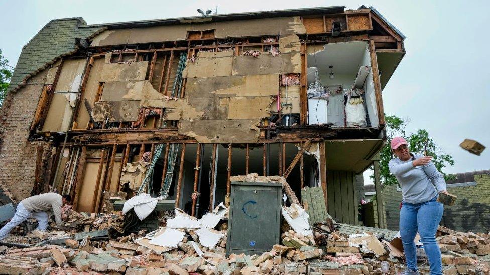 Woman clearing debris in Houston