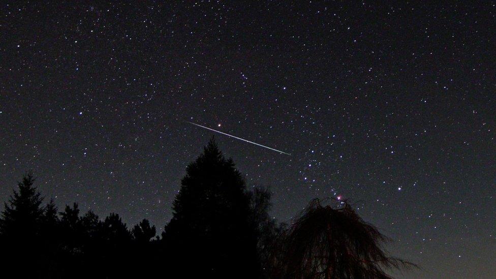 Geminid meteor shower seen across a night sky near Hay-on-Wye, Wales