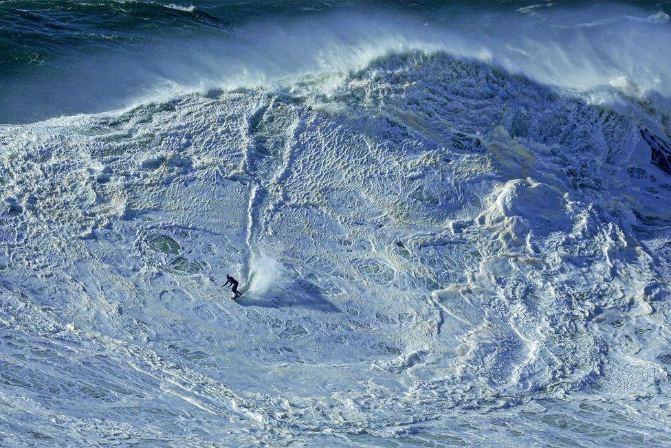 Will Santana of Brazil during a surfing session at Praia do Norte in Nazare, Portugal