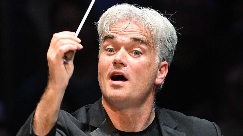 Edward Gardner holding up a conductor's baton mid performance at the BBC Proms at the Royal Albert Hall on Friday 11 August 2023