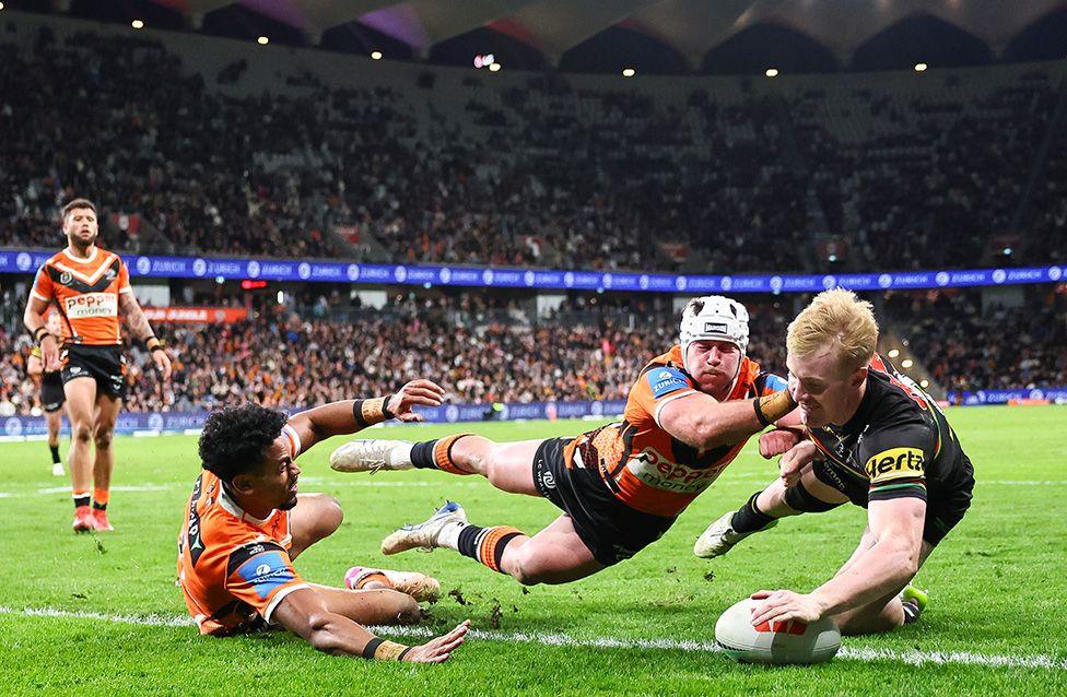 Thomas Jenkins of the Panthers celebrates scoring a try against the Wests Tigers in Sydney, Australia. Photo by Jeremy Ng