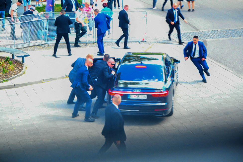 Security officers move Slovak PM Robert Fico in a car after he was injured in a shooting incident, after a Slovak government meeting in Handlova, Slovakia, May 15, 2024