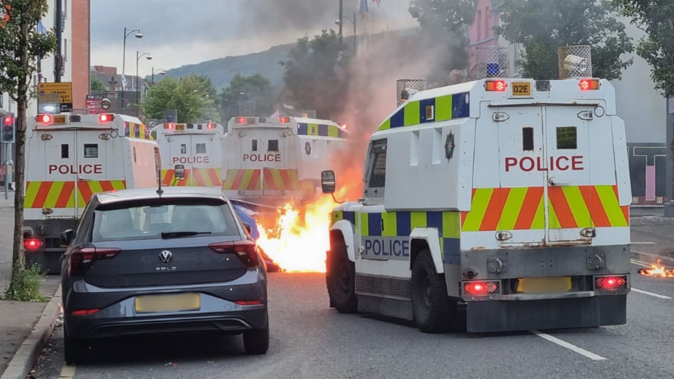 Flames near police vehicles in Northern Ireland