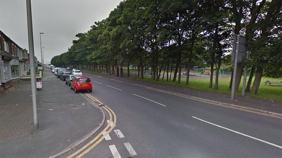 Watson Road, Blackpool, showing shops and a children's park