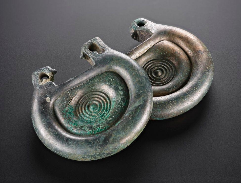 Two Bronze Age fittings with a spiral motif