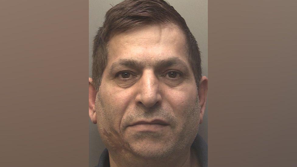 A police custody photograph of Ibrahim Cetin who has dark hair and brown eyes and is looking into the camera.