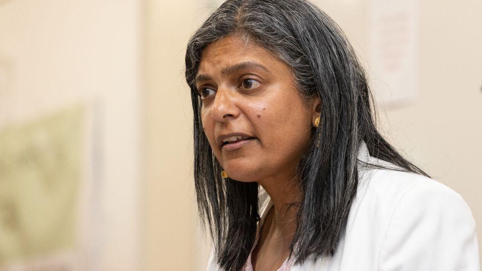 Labour Party MP Rupa Huq speaks at the Acton Residents Association hustings in June in London. She has her black hair down and is wearing a white jacket.